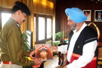 Governor gifting a book on indigenous tribes of Arunachal Pradesh to DG of the CRPF, 