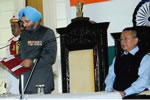 Governor administering oath of office and secrecy to new cabinet ministers as Chief Minister looks on: 20/05/2011