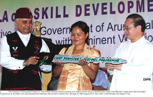 The Governor of Arunachal Pradesh Lt. Gen (Retd) Nirbhay Sharma landing over replica tractor key to a beneficiaries under Chief Ministers Agriculture Mechanization Programme at Job Mela cum skill development interview rally at Indira Gandhi Park, Itanagar on 30th August 2013. Also seen: Chief Minister Shri Nabam Tuki