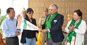 The Governor of Arunachal Pradesh Lt. Gen (Retd) Nirbhay Sharma handing over the flagged Ice Axe to Smt Anshu Jamsenpa who is attempting a double ascent of Mt Everest, at Raj Bhawan, Itanagar on 3rd April 2014. Also seen: The First Lady of the State, Smt Jyotsna Sharma and Smti Anshu Jamsenpas husband and the President of Arunachal Mountaineering & Adventure Sports Association, Shri Tsering Wange