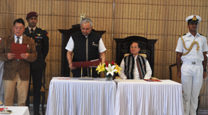 The Governor of Arunachal Pradesh Lt. Gen (Retd) Nirbhay Sharma administrating the oath to the Pro-tem Speaker Shri Kameng Dolo, a senior member of the Sixth Legislative Assembly of Arunachal Pradesh at Raj Bhawan, Itanagar on 30th May 2014. Also seen : Chief Minister Shri Nabam Tuki