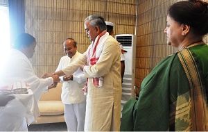 A member of Brahma Kumari tying Rakhi to the Governor of Arunachal Pradesh Lt. Gen (Retd) Nirbhay Sharma on the occasion of Raksha Bandhan at Raj Bhawan, Itanagar on 10th August 2014: Also seen in the right: First Lady of the State Smt Jyotsna Sharma.